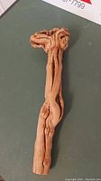 Top view of wooden carved object showing natural knots and wood grain