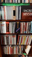 Full shelf of assorted classical music CDs by various artists and composers in jewel cases and cardboard sleeves.
