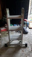 Convertible ladder folded and standing upright showing compact configuration.