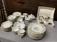 Full set of vintage Kings Court china pieces including plates, bowls, sugar and honey bowls, and silver plated flutes shown on table.