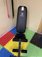 Photo of Marcy weight bench backrest and foam rollers, showing logo and condition.