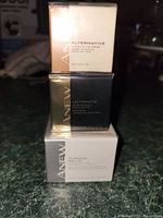 Stacked view of three sealed Avon Anew eye cream boxes showing front labels with product names and weight 15 ml (0.5 fl. oz).