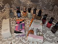 Assorted small nail polish bottles with nail care products displayed on lace fabric