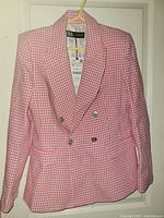 Front view of Zara pink and white checkered blazer with tags visible on a hanger
