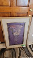 Full view of Southwest style signed wall art under glass with purple background, white mat, and textured wood frame.