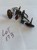 Photo showing six sterling silver rings, emphasizing the variety of stones and designs including turquoise inlay and amber stone.