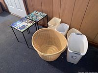 Full lot showing two garden tables, three trash cans, two laundry baskets