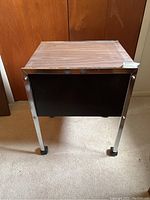 Image of the wood and steel rolling cart showing front view with wood top and steel frame with wheels.