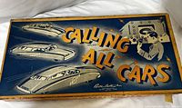 Game box top showing 'Calling All Cars' text and artwork with futuristic cars and a radio operator, box shows wear and damage.