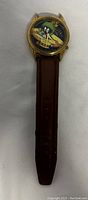 Full watch with Marvin the Martian design on dial and partial brown wrist band visible.