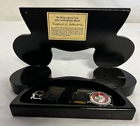 Full view of the original Mickey Mouse head-shaped black wood box open, showing inside the wristwatch and Certificate of Authenticity plaque on box lid.