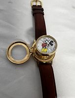 Front view of Mickey Mouse popup watch with popup cover opened to reveal watch face showing Mickey Mouse.