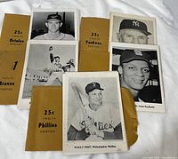 Overview of five team envelopes and sample photos laid out on white background
