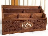 Full view of the wooden desk organizer showing five slots and carved front panel.