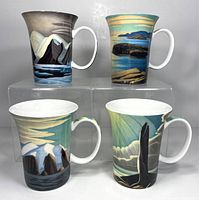 Front and top angled view of four porcelain cups with stylized landscape artwork on display
