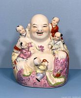Front view of vintage Chinese Laughing Buddha figurine with children, showing painted details and colorful robes.
