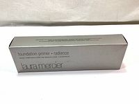 Front view of unopened silver box labeled Laura Mercier Foundation Primer Radiance.