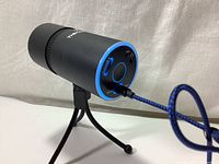 Side angle showing microphone controls, including volume, gain, mute button, and USB Type-C cable attached.