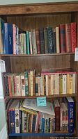 Books arranged on shelves, featuring classic and novel titles in hardcover and paperback.