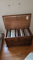 Lane cedar chest opened showing interior with vinyl records stored inside.