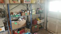 Front and side view of two metal shelving units loaded with various household and garage items, showing their size and condition with oxidation visible