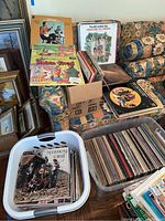 Photo showing box and bins filled with vinyl albums, including colorful children's albums and Pete Seeger LP in a basket