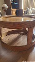 Side view of round wood coffee table showing circular structure and wood grain detail