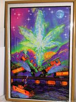 Full view of framed poster showing main artwork with large cannabis leaf, two trains crashing and colorful background.