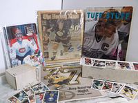 Lot overview showing magazines, hockey cards in box and memorabilia.