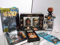 Full view of Star Wars collectible lot including Pop figure, Darth Maul puzzle, magazine, DVD and cards.