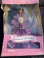 Glamour Princess doll in purple and silver dress in original pink box with clear display front, showing condition of packaging.