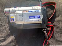 JVC GR-SXM730 Super VHS camcorder side view showing branding, Super VHS logo, digital zoom and model details
