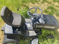 Side view of Murray Select Wide Body LT riding lawn mower showing seat, steering wheel, tires, and mower body labeled Select