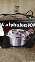 Front view of the Calphalon pressure cooker's box showing the product image and brand name.