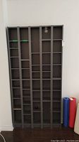 Front view of the tall wooden shelving unit showing all five vertical sections with adjustable compartments and shelves.