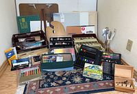 Full lot laid out including canvases, pastels, palettes, pallets, colored pencils, oil paints, brushes, pads and drafting tools.