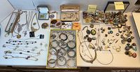 Overall view of necklaces, bracelets, brooches, earrings and pendants arranged on table