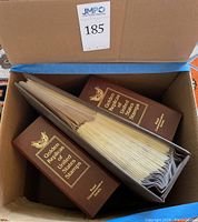 Box containing two bound albums and one ring binder sleeve