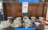 Full display of 10 individual teacup and saucer pairs with one display plate