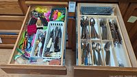 Close-up photo of utensils in drawer showing serrated knives, small whisks, picks, and other kitchen tools.