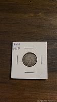 Obverse side of the 1917 Newfoundland silver 10 cent coin, showing the date and denomination within wreath.