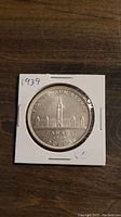 Reverse side of the 1939 Canadian Silver Dollar featuring Canadian Parliament buildings and inscriptions