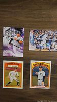 Photo of four Aaron Judge baseball cards including Superstar Secrets, In Action, Yankees, and an action batting card.