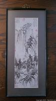 Full view of framed Chinese print showing entire artwork with frame and matting on wooden surface.