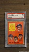 Front of the 1962 Topps AL Home Run Leaders card showing four players on orange background: Roger Maris, Mickey Mantle, Harmon Killebrew, Jim Gentile. Encased in PSA slab with label showing PSA grade VG 3.