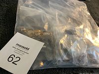 Photo showing the full sealed bag with various pieces of jewelry inside, packaged separately in clear plastic bags.