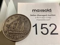 Front side of the 1949 Canadian one dollar coin showing the sailing ship and inscriptions