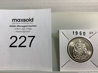 Photo of the 1960 Canadian Silver Half Dollar coin in protective holder with lot number 227 shown.