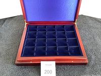 Open coin display box showing one level of 24 blue velvet-lined coin slots.