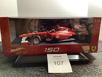 Front view of the Hot Wheels Racing Ferrari 150 Italia 1:18 scale model car in original box with clear display window.